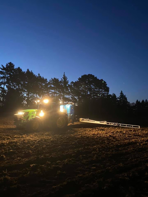 Tractor working under lights at night