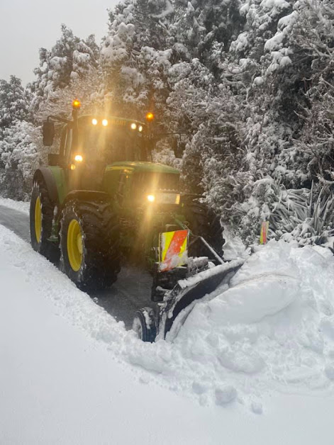 John Deere tractor clearing snow